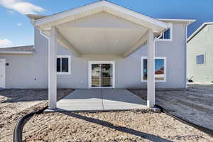 Back of house featuring a patio and stucco siding