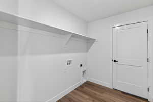 Laundry area featuring dark wood-style flooring, electric dryer hookup, and washer hookup