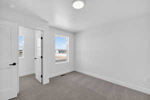 Unfurnished bedroom with carpet flooring and a textured ceiling