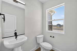 Bathroom with toilet and baseboards