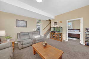 Living area with stairs and carpet