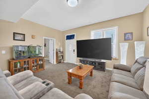 Carpeted living area featuring baseboards