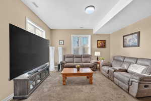 Living area featuring plenty of natural light and carpet flooring