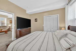 Bedroom featuring carpet flooring and a closet