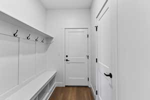 Mudroom featuring dark wood finished floors