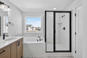 Full bathroom with vanity, a marble finish shower, a garden tub, a textured ceiling, and recessed lighting