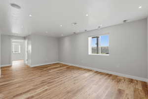 Spare room featuring light wood finished floors and recessed lighting