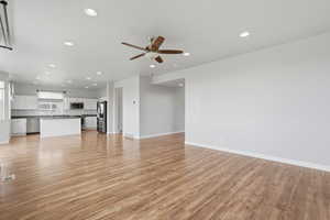 Unfurnished living room with ceiling fan, light wood-style flooring, and recessed lighting
