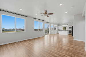 Unfurnished living room with ceiling fan, light wood-style flooring, and recessed lighting