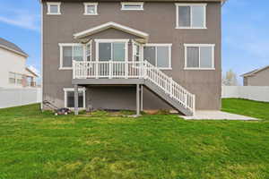 Rear view of property with a fenced backyard, stucco siding, and a wooden deck