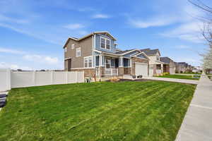 Craftsman-style home featuring stone siding, board and batten siding, concrete driveway, an attached garage, and a residential view