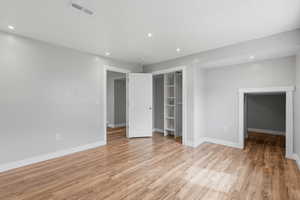 Unfurnished bedroom with recessed lighting, light wood finished floors, and a closet