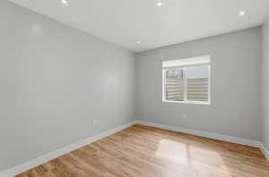 Spare room featuring light wood-type flooring and recessed lighting