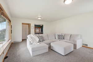 Living room featuring baseboards and carpet flooring
