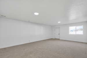 Empty room featuring carpet floors and recessed lighting