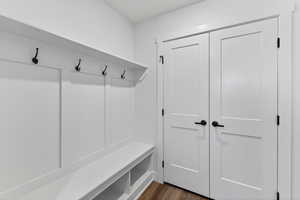 Mudroom with dark wood finished floors