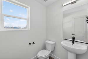 Bathroom with toilet and baseboards
