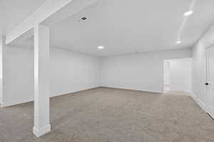 Finished basement featuring light carpet and recessed lighting