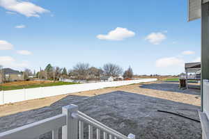 Fenced backyard with a residential view and a patio area