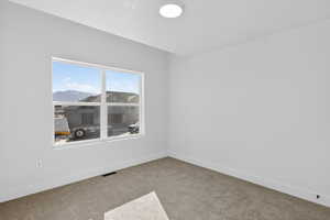 Unfurnished room with baseboards and light carpet
