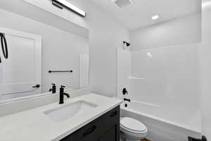 Bathroom with vanity and shower / washtub combination