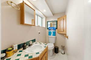 Half bath featuring vanity and recessed lighting