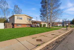 Split level home featuring brick siding and an attached garage