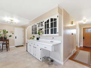 Foyer entrance featuring arched walkways and baseboards
