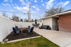 Fenced backyard featuring a patio area, an outdoor fire pit, and outdoor lounge area