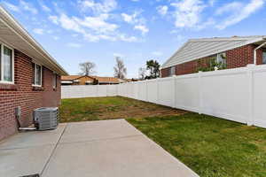 Fenced backyard featuring a patio area