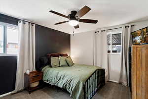 Carpeted bedroom featuring a ceiling fan