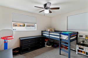 Carpeted bedroom with ceiling fan
