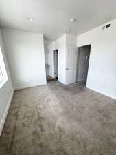 Primary room, Carpeted empty room featuring baseboards and a textured ceiling