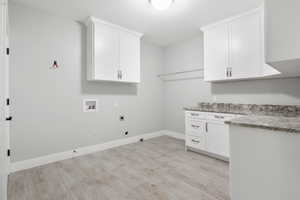 Laundry room with hookup for a gas dryer, cabinet space, hookup for a washing machine, and electric dryer hookup