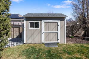 View of shed featuring a fenced backyard