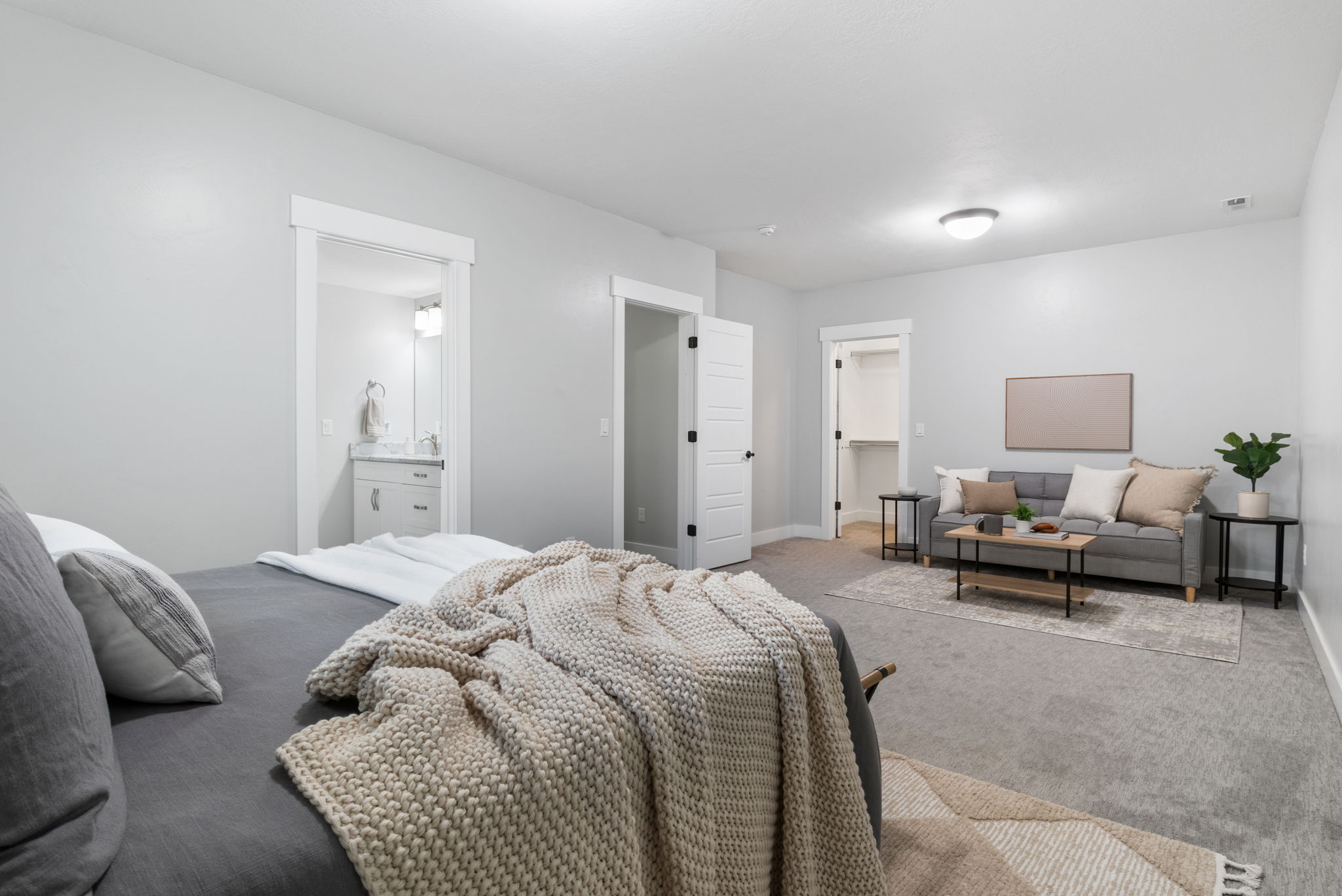 Bedroom with carpet, a walk in closet, and connected bathroom