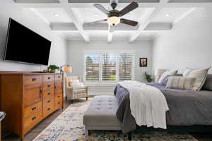 Primary Bedroom with coffered ceiling, ceiling fan, ornamental molding, dark wood finished floors, and recessed lighting