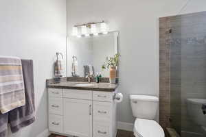 Bathroom with vanity and a stall shower