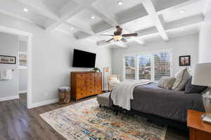 Primary Bedroom with recessed lighting, dark wood finished floors, ceiling fan, coffered ceiling, and ornamental molding