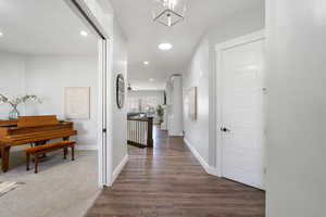 Hallway featuring recessed lighting and dark wood-style floors