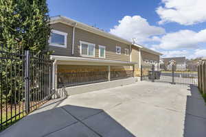 Back of property featuring a gate, a patio area, and driveway