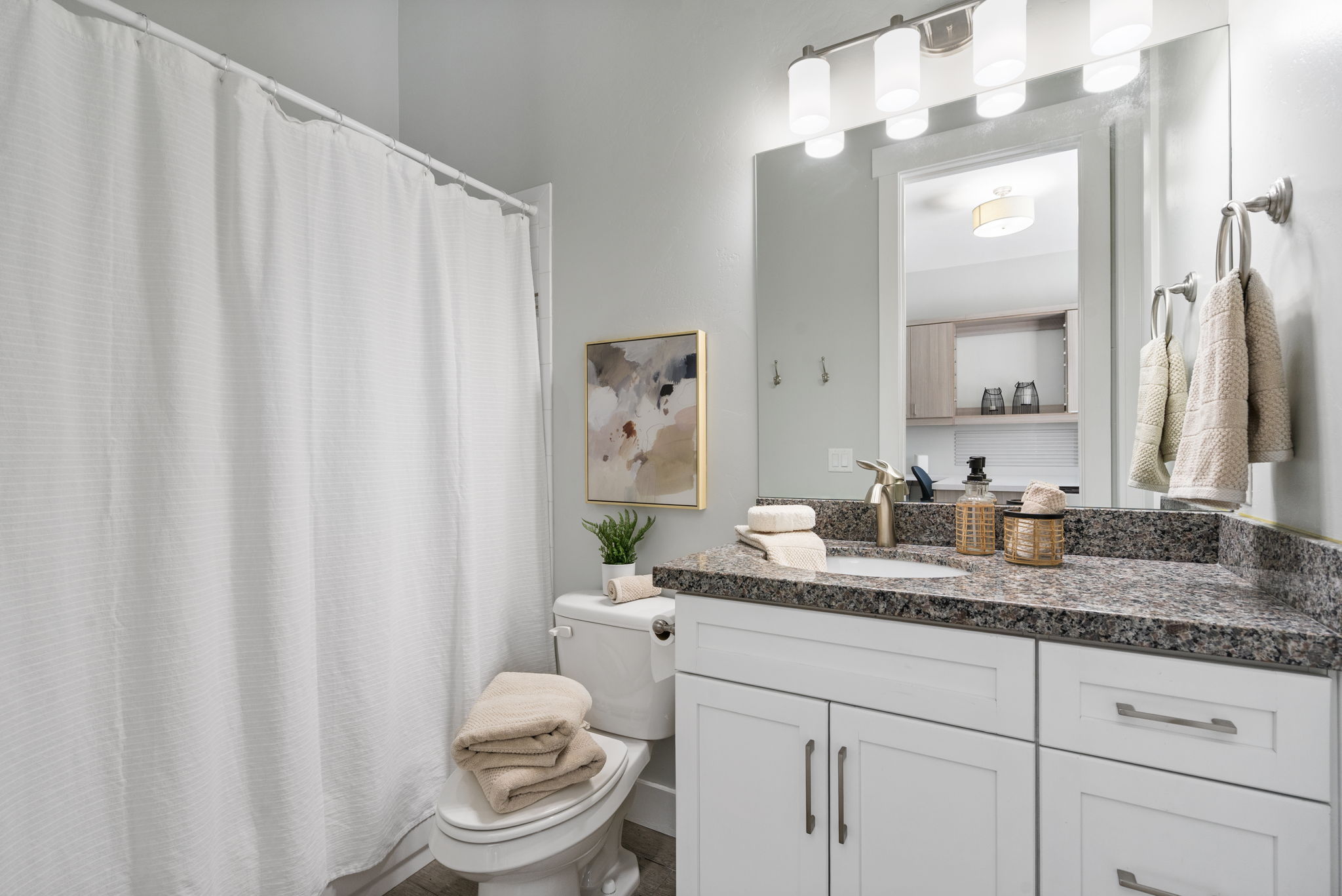 Full bath featuring a shower with shower curtain and vanity