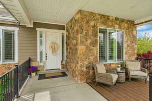 Property entrance featuring stone siding
