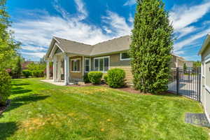 Expansive green lawn with established landscaping, including mature trees and shrubs