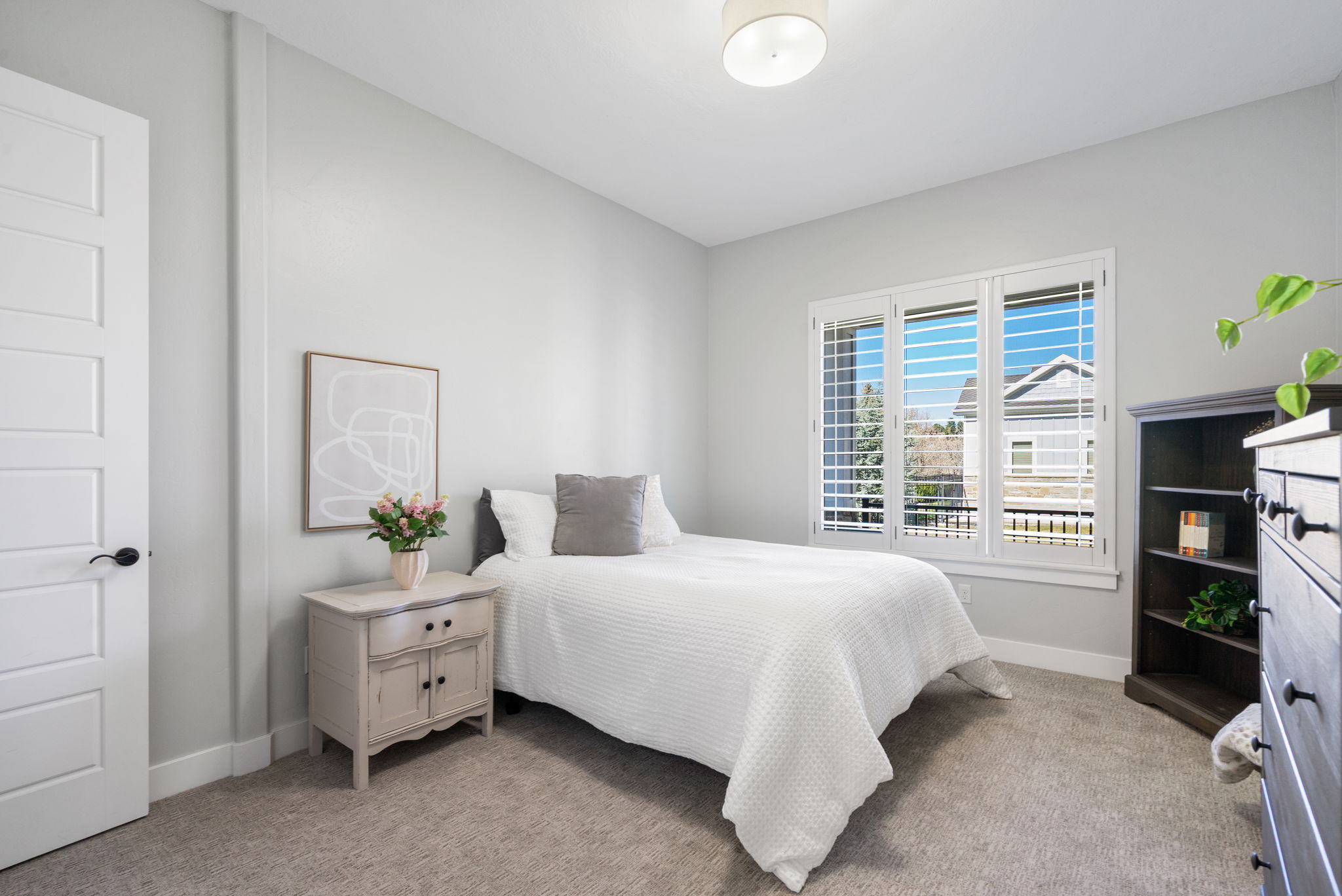 Bedroom featuring light carpet