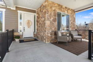 Entrance to property featuring stone siding
