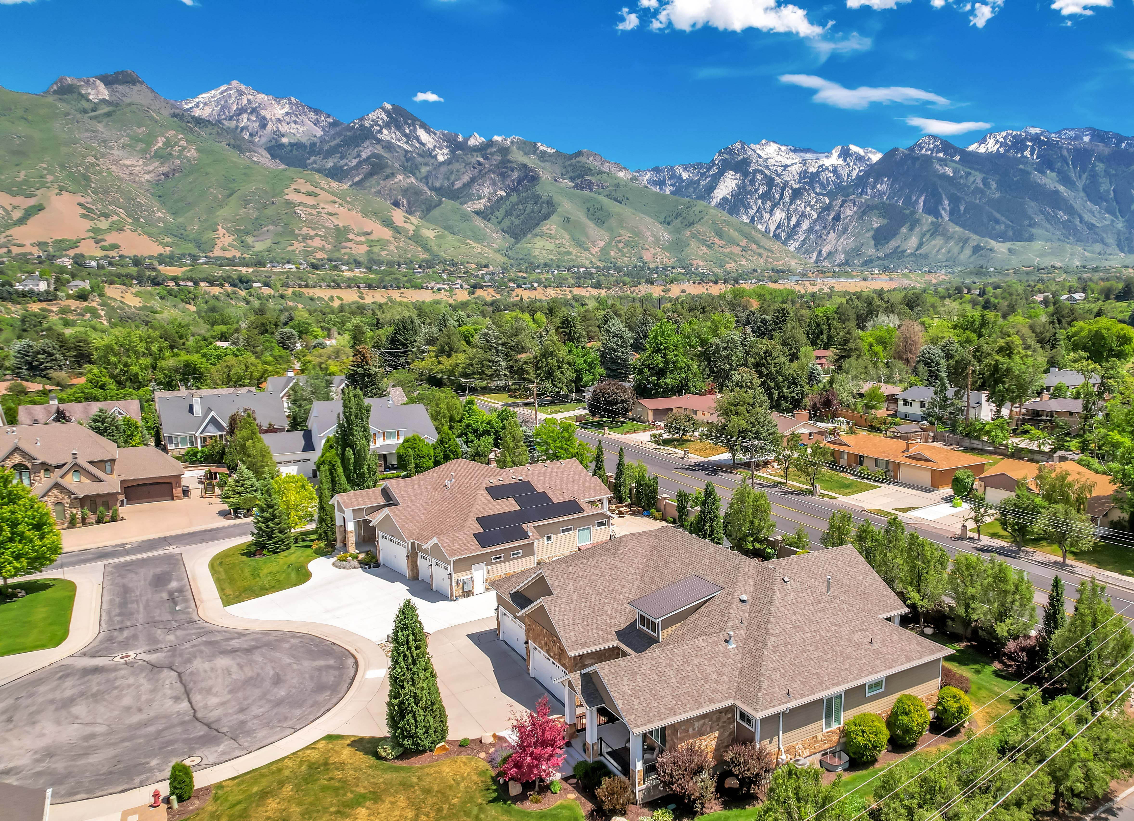 Elevated aerial panorama showcasing a residential neighborhood with mountain scenery