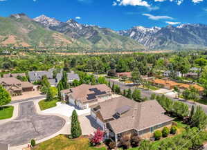 Elevated aerial panorama showcasing a residential neighborhood with mountain scenery