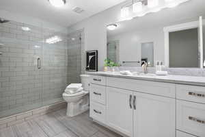 Bathroom with a shower stall and vanity