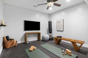 Exercise area with baseboards and a ceiling fan